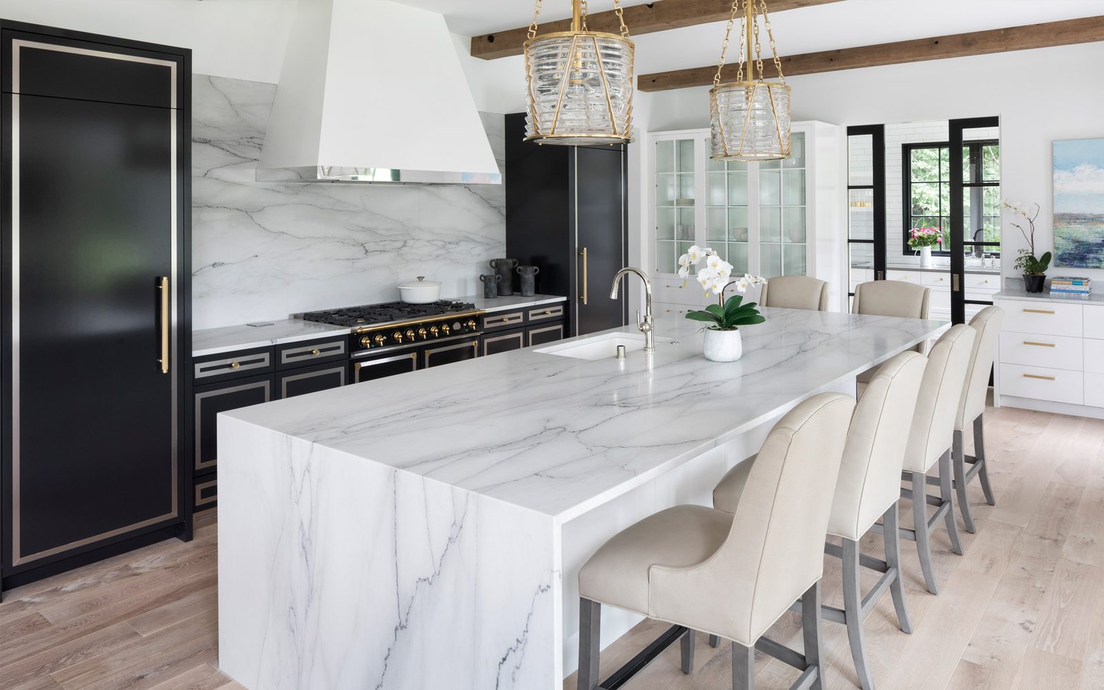 Renovated high-end kitchen with marble waterfall island