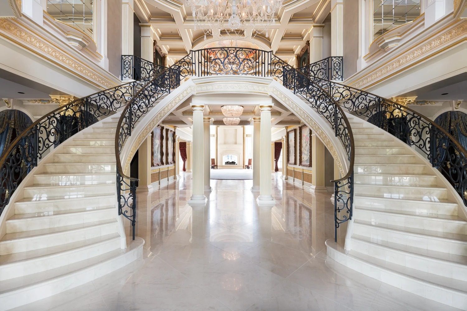 Grand staircase with iron railing and millwork